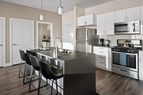 a kitchen with a black counter top and appliances at Convention Ctr - Stylish 2BD,2BA with Pool,Gym and Hot tub in Salt Lake City