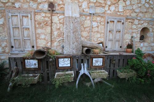 a stone building with a fireplace in the yard at Beymelek Tas Evler in Demre