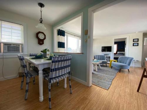 a kitchen and living room with a table and chairs at North Truro Pet-friendly home near Secluded Beach in Provincetown