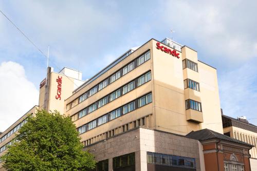 a building with a sign on the top of it at Scandic Julia in Turku