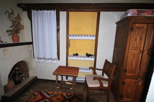a room with a table and chairs and a window at Beymelek Tas Evler in Demre