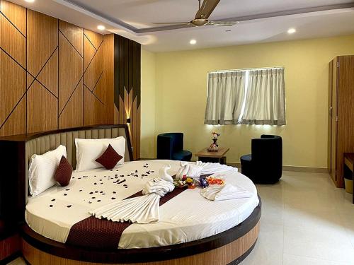 a bedroom with a large bed with flowers on it at Sonargaon Beach Resort in Mandarmoni
