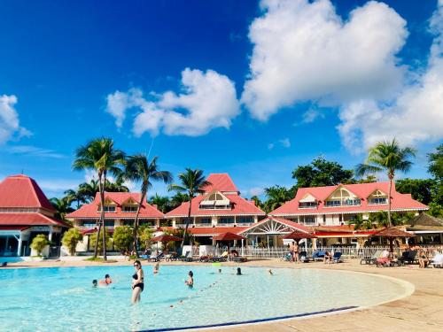 a group of people in the swimming pool at a resort at TIKAZADAPH, pour un séjour de charme, romantique & exotique, 97180 Sainte-Anne in Sainte-Anne