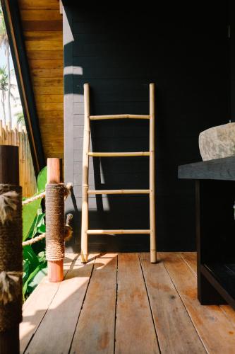 a wooden chair sitting on top of a wooden floor at Desa Cabins in Balian