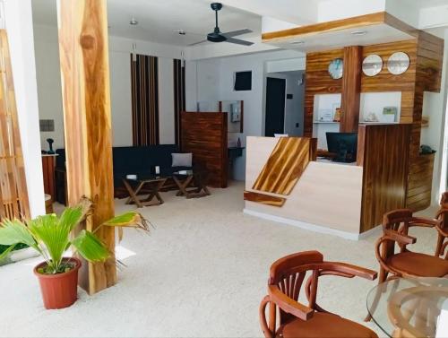 a living room with chairs and a table at Turtle Hive - Velaa Vani in Dhiffushi