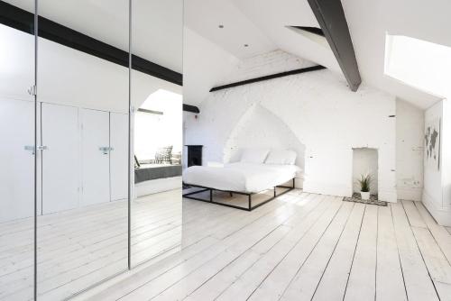 a bedroom with a bed and a glass wall at Central Cardiff Victorian Town House Free parking in Cardiff