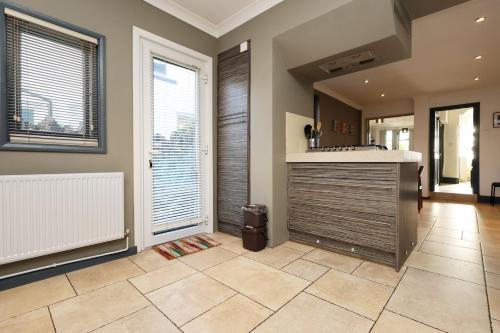 a kitchen with a counter and a large window at Central Cardiff Victorian Town House Free parking in Cardiff