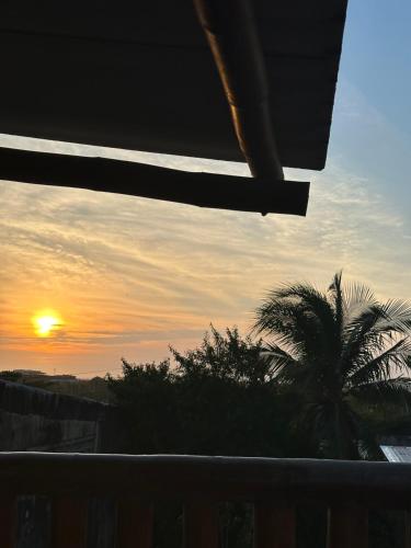 カルタヘナ・デ・インディアスにあるHostal Bambumarのヤシの木のあるバルコニーからの夕日