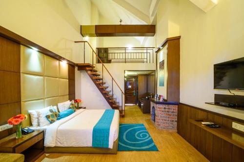 a bedroom with a bed and a staircase at Sinclairs Retreat Kalimpong in Kalimpong