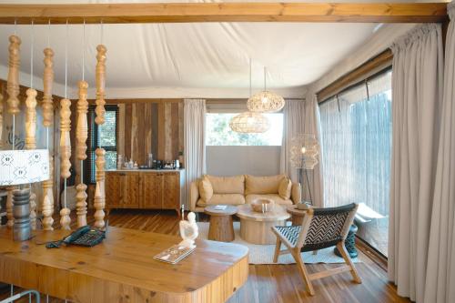 a living room with a table and a couch at Pearl Mara in Masai Mara