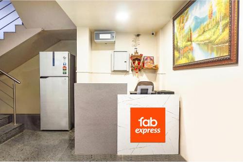 a fico express sign in a room with a refrigerator at Hotel Star Light - Near Jagtap dairy in Pune