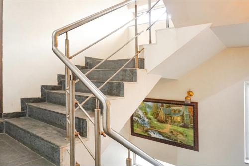 a staircase in a house with a painting on the wall at Hotel Star Light - Near Jagtap dairy in Pune