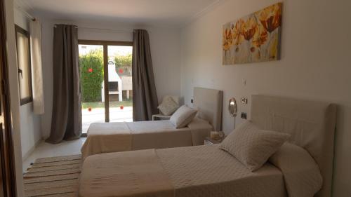 a hotel room with two beds and a couch at Beach House Llenaire in El Port