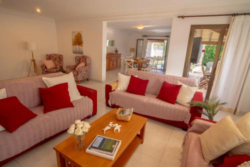 a living room with two couches and a table at Beach House Llenaire in El Port
