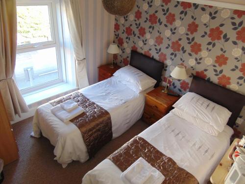 A bed or beds in a room at The Hub at Abercrave