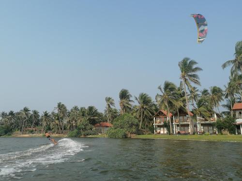 a person is kite surfing on a body of water at Kitekuda Kite Resort in Vannativillu
