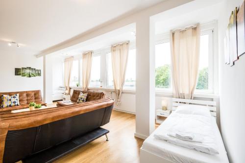a bedroom with a bed and a large window at Work & stay Langenfeld in Langenfeld