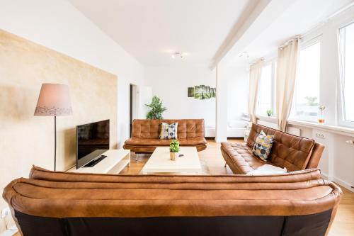 a living room with a couch and a fireplace at Work & stay Langenfeld in Langenfeld