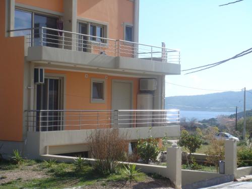 a house with a balcony on the side of it at Sandra's Sea View at Sounio in Sounio