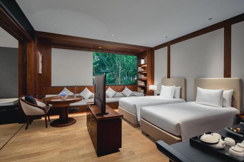 a hotel room with two beds and a television at Tonino Lamborghini Hotel Suzhou in Suzhou