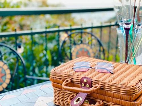 a wicker basket with sunglasses on top of it on a table at 【マリンブルー風オーシャンビュー】貸切ヴィラ WIFI付/BBQ可能/最大6名/無料駐車場 in Okawa