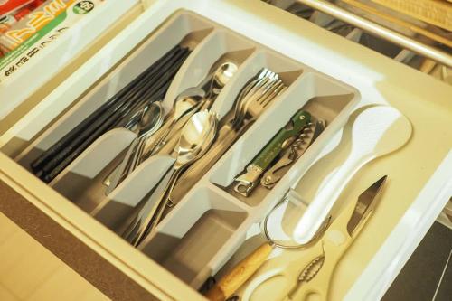 a drawer with utensils in a white box at 【芦ノ湖徒歩10分＆バス停1分】一棟貸切最大14人 大人數BBQ可能 パーティ 『ROUTE99』 in Moto-hakone