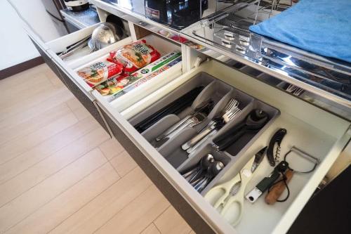 an open refrigerator drawer filled with lots of food at 【芦ノ湖徒歩10分＆バス停1分】一棟貸切最大14人 大人數BBQ可能 パーティ 『ROUTE99』 in Moto-hakone