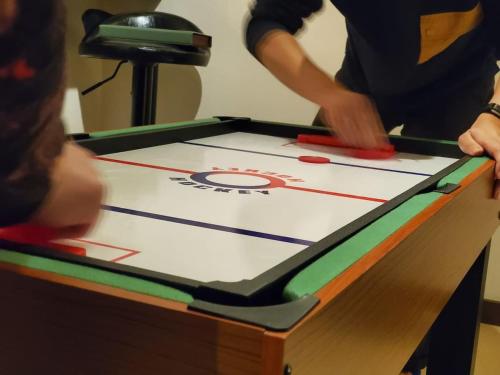 a man playing a game of ping pong on a table at 【芦ノ湖徒歩10分＆バス停1分】一棟貸切最大14人 大人數BBQ可能 パーティ 『ROUTE99』 in Moto-hakone