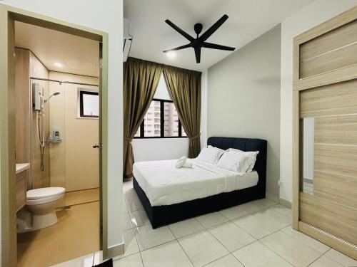 a bedroom with a bed and a toilet and a ceiling fan at Youth City Residence in Nilai