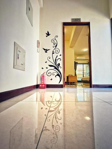 a hallway with a wall with birds decals on it at Peninsula Travel B&B in Hengchun