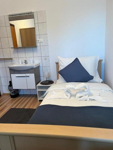 a bedroom with a bed with a sink and a mirror at Cheers Diner & Rooms in Villach