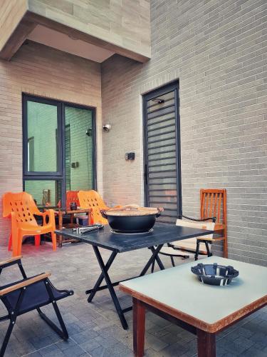 a table with a bowl on it on a patio at Peninsula Travel B&B in Hengchun