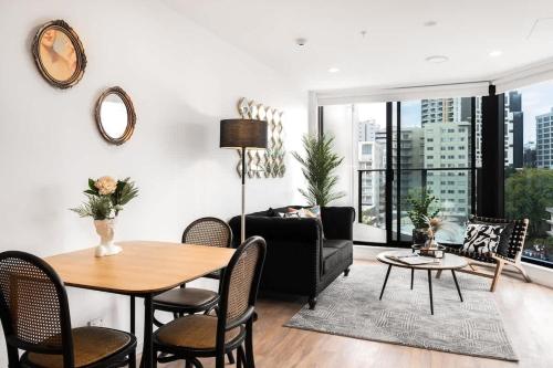 a living room with a table and a couch at Luxury Design Parkside Living in CBD vs Aircon in Auckland