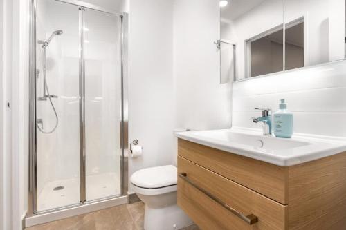a bathroom with a shower and a toilet and a sink at Luxury Design Parkside Living in CBD vs Aircon in Auckland