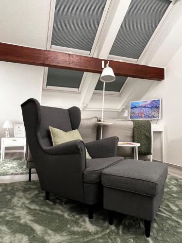 a living room with a couch and a chair at Altstadtnest in Greifswald