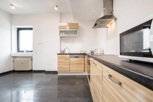 a kitchen with white walls and a black counter top at Work & stay Langenfeld in Langenfeld
