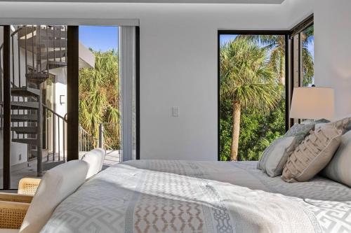 a bedroom with a large bed with a large window at Heated Pool & Rooftop Near Intracoastal in Boynton Beach