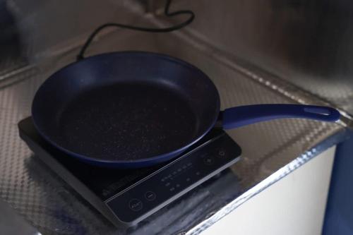 a black frying pan sitting on top of a appliance at Hakone 8mins walk-modern style FreeNetflix Switch - Unit 204 in Hakone