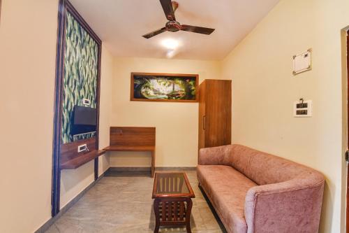 a living room with a couch and a table at Jingle Tree Resort - Nr Arambol Beach in Pernem