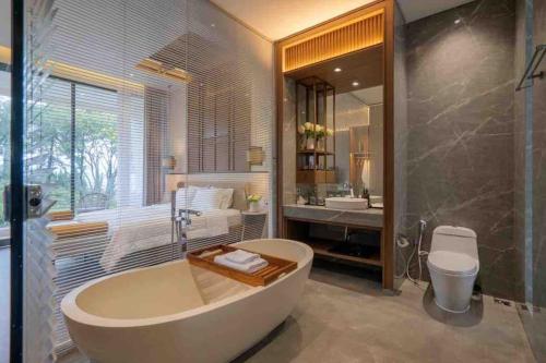a large bathroom with a tub and a sink at ALCOLA Villa - Bahama Unit 3BR with private pool in Malang