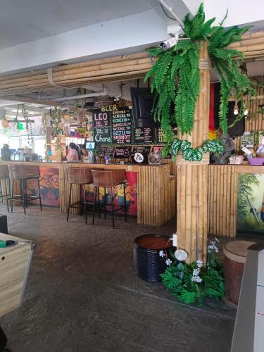 a restaurant with a bar with tables and chairs at Haadrin village Fullmoon in Haad Rin