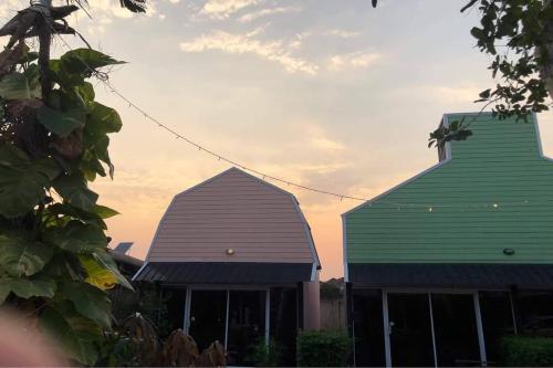 two roofs of two buildings with the sky in the background at Pai Tawan Resort Hotel - Pet friendly in Khon Kaen