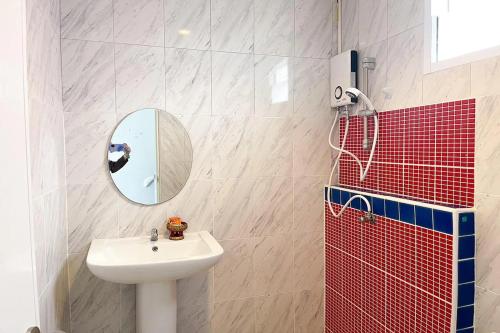 a bathroom with a sink and a mirror at Pai Tawan Resort Hotel - Pet friendly in Khon Kaen