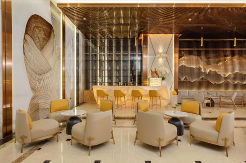 a lobby with tables and chairs and a bar at PANAMA Nha Trang Hotel in Nha Trang