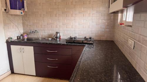 a kitchen with a sink and a counter top at NightNest hospitality service Independent flat Kompally in Hyderabad