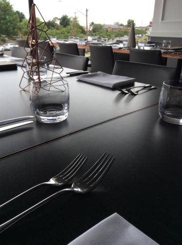 a table with a fork and a vase on it at The Charles in Wagga Wagga