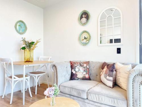 a living room with a couch and a table at Lime-Fresh Garden Atmosphere CBD 1B Pool Sauna Gym in Auckland