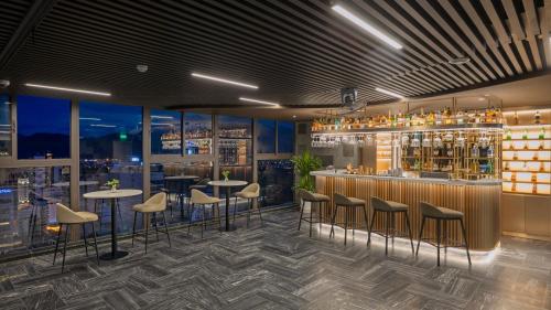 a bar with stools and tables in a restaurant at PANAMA Nha Trang Hotel in Nha Trang