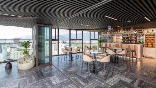 a restaurant with tables and chairs and a bar at PANAMA Nha Trang Hotel in Nha Trang