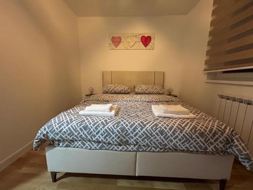 a bedroom with a bed with two towels on it at Sun&moon in Donje Mladice
